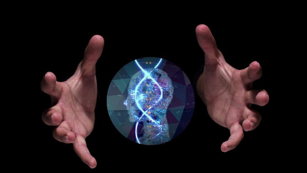 A composite image of a pair of hands on a black background, with the light silhouette of a head between them