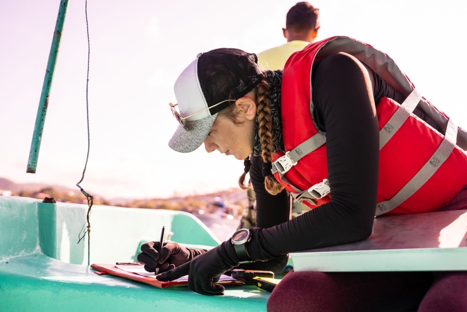 Person in wetgear taking notes